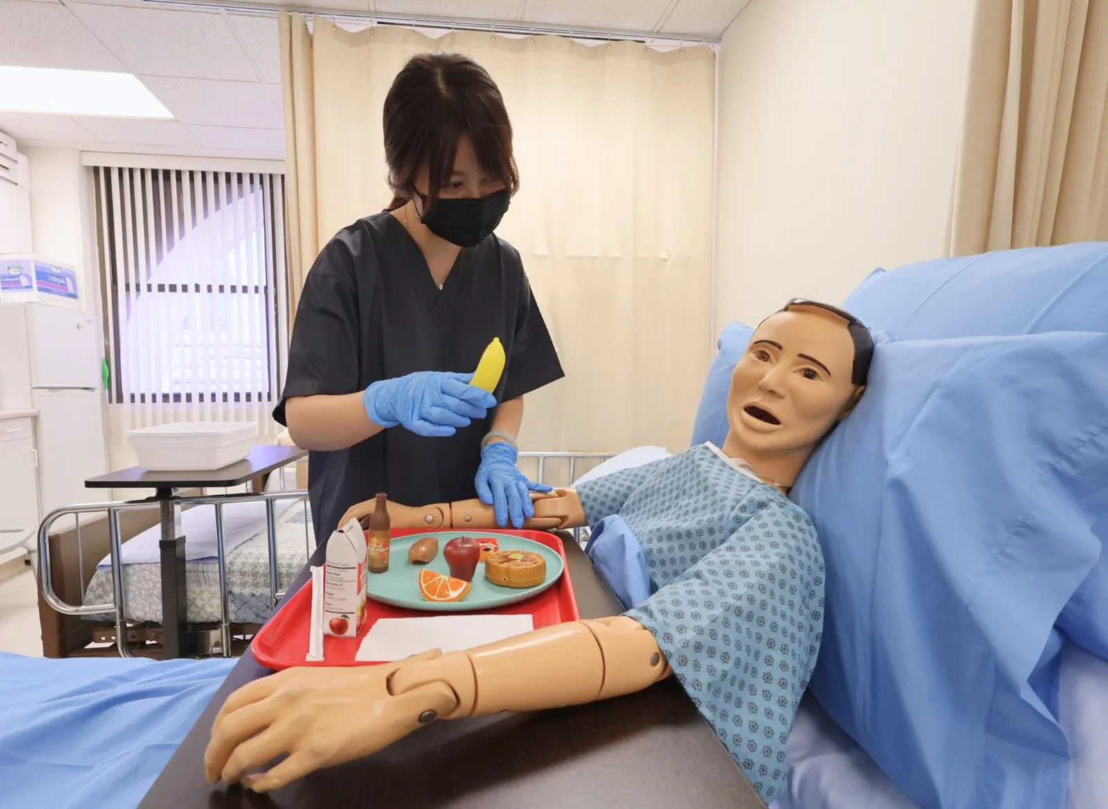 HHCS instructor with a training mannequin