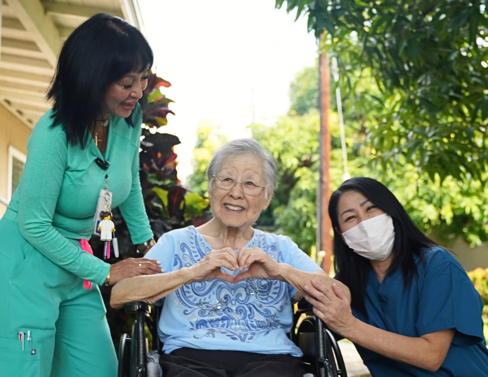 Hale Kiapu caregivers with a resident